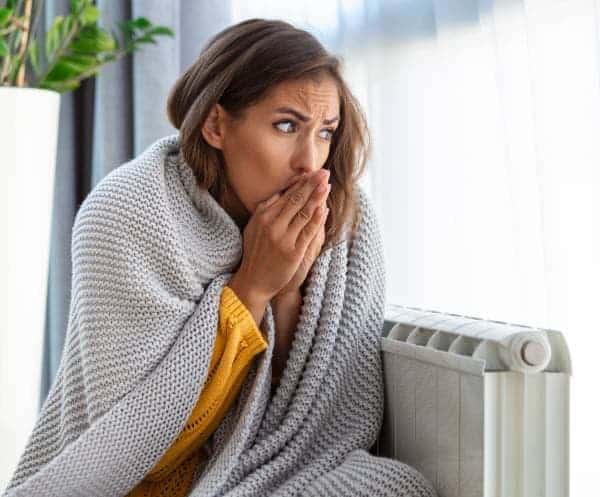 lady with blanket, cold, next to radiator